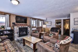 a living room with couches and a fireplace at Our Lakeside Legacy in Saint Germain