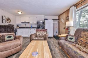 a living room with two couches and a table at Our Lakeside Legacy in Saint Germain