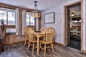 a dining room with a table and chairs and a bedroom at Our Lakeside Legacy in Saint Germain +23 photos