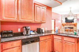 a kitchen with wooden cabinets and a counter top at Chula Vista Condo 2251 in Wisconsin Dells +26 photos