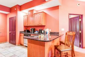 a kitchen with orange walls and a counter and chairs at Chula Vista Condo 2251 in Wisconsin Dells