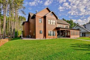 a large wooden house with a large yard at Endless Summer in Sayner