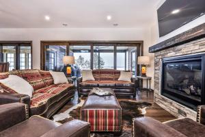 a living room with couches and a fireplace at Endless Summer in Sayner