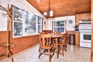 a kitchen with a table and chairs and windows at Watermelon Retreat in Three Lakes