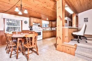 a kitchen with a table and chairs in a room at Watermelon Retreat in Three Lakes