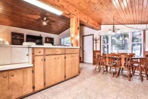 a kitchen and dining room with a table and chairs at Watermelon Retreat in Three Lakes +22 photos