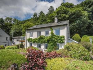 a white house with ivy growing on it at 3 Bed in Keswick oc-sz540 in Applethwaite