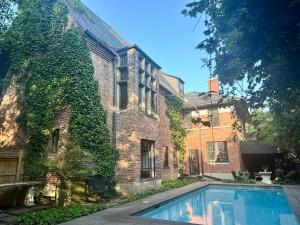 a brick house with a swimming pool in front of it at The Mayfair Castle in Buffalo