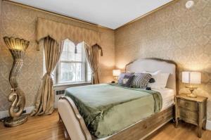 a bedroom with a large bed and a window at The Mayfair Castle in Buffalo +14 photos