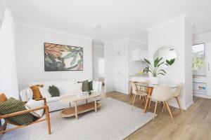 a living room with a couch and a table at Coastal Bliss in Lemon Tree Passage