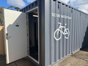 a metal building with a bike sign on it at Araluen Motor Lodge in Batemans Bay