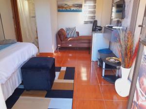 a living room with a bed and a couch at EcoGreen B&B On 222 Botha in Northam