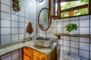 a bathroom with a sink and a mirror at Casa Selva in Dominicalito +47 photos