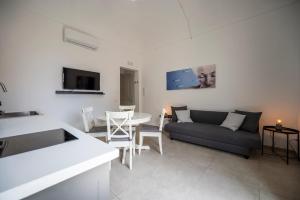 a living room with a couch and a table at Demetra in Noto