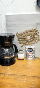 a coffee maker sitting on a table next to a mirror at Loft #1 a una cuadra de Playa Regatas Oyster Suites in Veracruz
