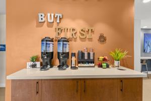 a coffee shop counter with a first sign on the wall at Good Nite Inn Buena Park in Buena Park