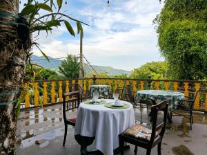 a table and chairs on a patio with a view at Cinque Terre Pousada & Bistrô in Rio de Janeiro
