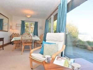a living room with a chair and a table at 3 Bed in Polruan oc-pc052 in Polruan +10 photos