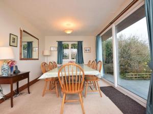 a dining room with a table and chairs and a window at 3 Bed in Polruan oc-pc052 in Polruan