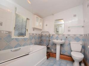 a bathroom with a toilet and a sink and a tub at 3 Bed in Polruan oc-pc052 in Polruan