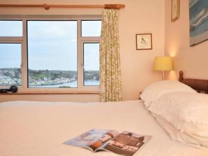 a bedroom with a bed and a window with a view at 3 Bed in Polruan oc-pc052 in Polruan