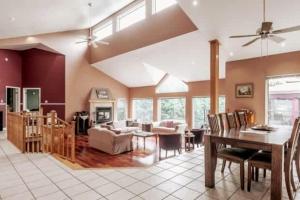 a living room with a table and a dining room at Le Chaleureux du Lac Blanc - Nominingue in Nominingue +28 photos