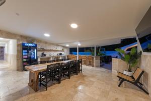 a large kitchen with a bar with stools at Caribe CBW in Willemstad
