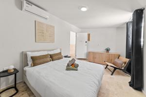 a bedroom with a bed with a teddy bear on it at Caribe CBW in Willemstad +38 photos
