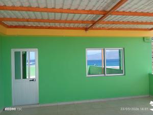 a room with a door and two windows at Casa Chez Zoe in Salamansa