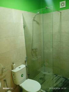 a bathroom with a toilet and a glass shower at Casa Chez Zoe in Salamansa +28 photos