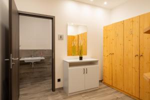 a bathroom with a sink and a mirror at Großer Strandkorb - Stilvolles Ferienapartment in der Alten Seefahrtsschule in Wustrow +16 photos