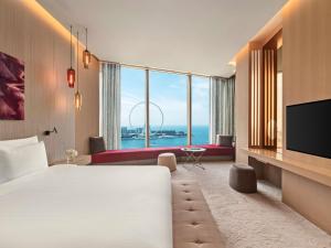a hotel room with a large bed and a large window at Rixos Premium Dubai JBR in Dubai