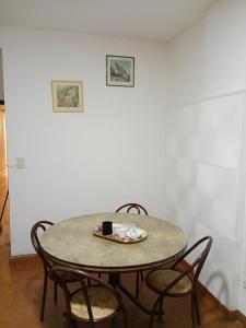 a table with chairs and a coffee mug on it at Lindo recuerdos in Posadas +3 photos