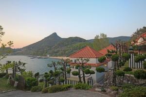 a house with a view of a lake and mountains at namhe acro pension in Namhae