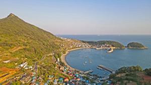 an aerial view of a town on a hill at namhe acro pension in Namhae +64 photos