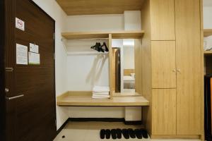 a small bathroom with a wooden cabinet and a mirror at The Rama Hotel in Chiang Rai +42 photos
