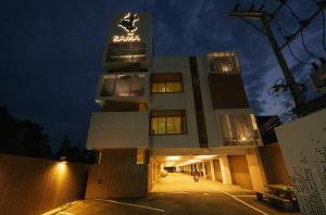 a building with a sign on the top of it at The Rama Hotel in Chiang Rai
