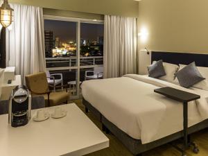 a hotel room with a bed and a view of a city at Mercure Sao Bernardo Do Campo in São Bernardo do Campo +106 photos