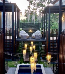 a room with a bed and a pool of water at Nawasena Suites in Sanur