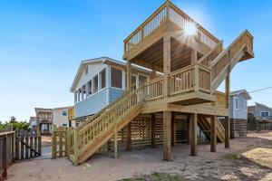 a large wooden house sitting on stilts at 4011 - The Dog`s House in Kitty Hawk