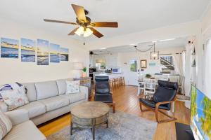 a living room with a couch and a ceiling fan at 4011 - The Dog`s House in Kitty Hawk +41 photos