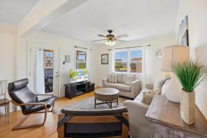 a living room with white walls and a ceiling fan at 4011 - The Dog`s House in Kitty Hawk