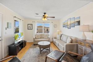 a living room with a couch and a tv at 4011 - The Dog`s House in Kitty Hawk