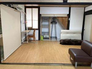 a living room with a couch and a table at 陽だまりハウス in Hiroshima