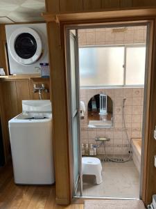 a small bathroom with a sink and a tub at 陽だまりハウス in Hiroshima +61 photos