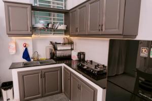 a kitchen with white cabinets and a counter top at HeavenVilla in Can Tho