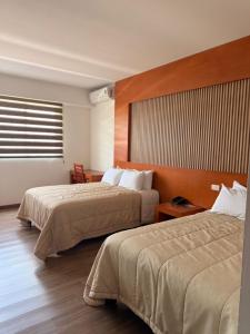 a hotel room with two beds and a window at Hotel Tlayolan in Ciudad Guzmán +31 photos