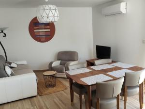 a living room with a table and a couch at VILLAS-Piscine les MIMOSAS in Fréjus