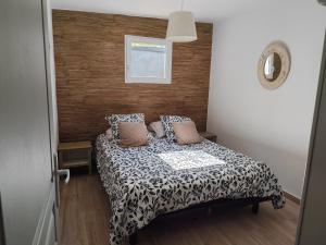 a small bedroom with a bed with pillows at VILLAS-Piscine les MIMOSAS in Fréjus +37 photos