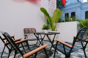 a group of chairs and a table on a patio at HeavenVilla in Can Tho